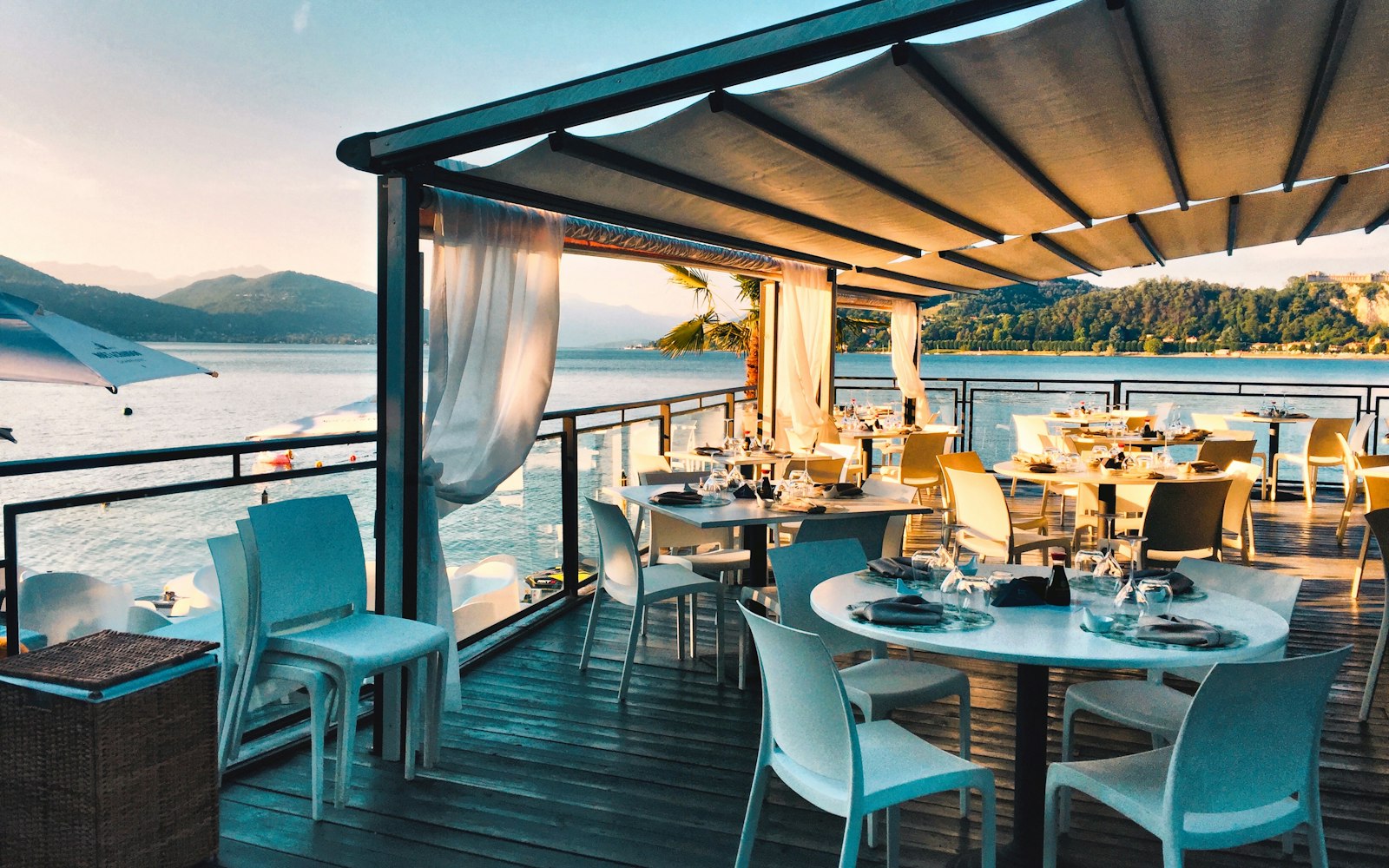 Tables set for dinner on our harbour terrace at sunset