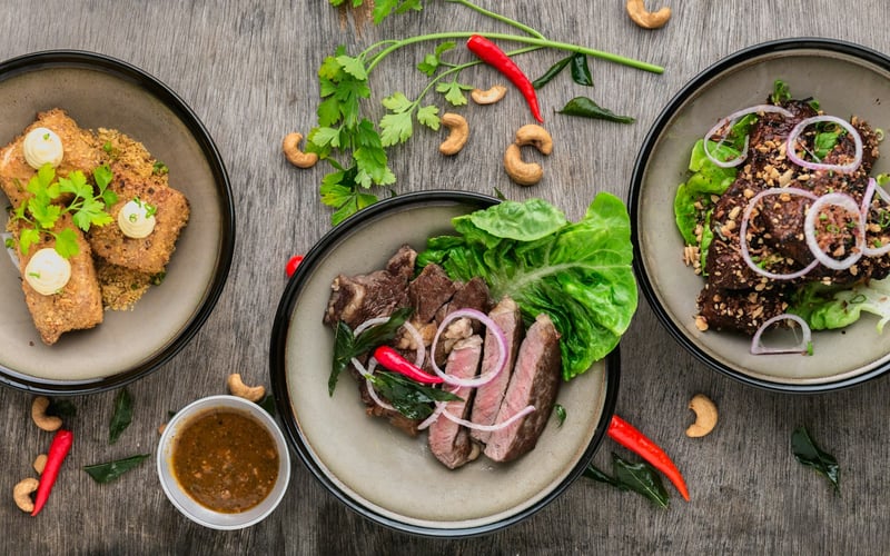 Three small sharing plates on a weathered table
